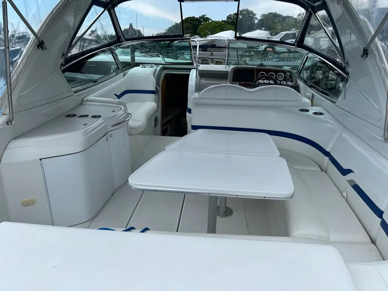 Slide: The Image of 2003 Formula 330 Sun Sport boat interior with white seating and table. - 5