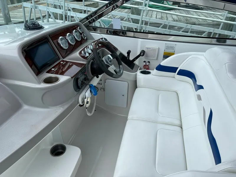 Slide: The Image of 2003 Formula 330 Sun Sport boat interior with white seating and control panel. - 9