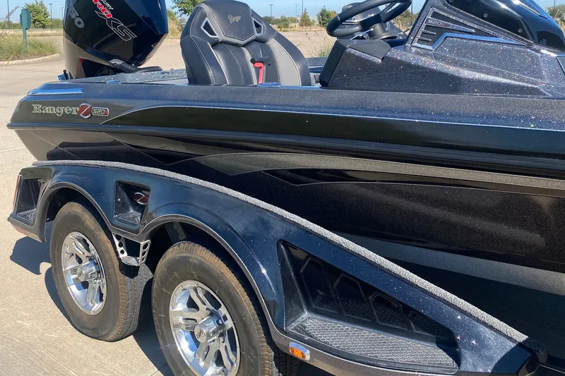 Slide: The Image of 2023 Ranger Z520R boat interior with carpeted deck and dual seats. - 11