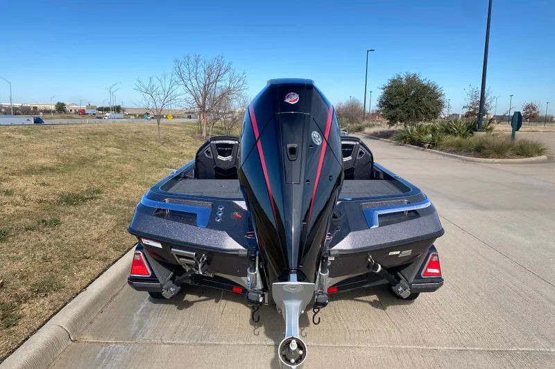 Slide: The Image of 2023 Ranger Z520R boat with powerful outboard motor, parked on a sunny day. - 13