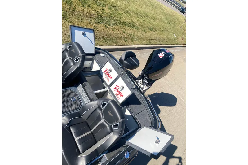 Slide: The Image of 2023 Ranger Z520R boat deck with cushioned seat and storage compartments. - 8