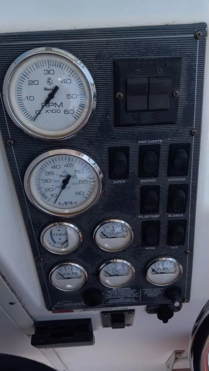 Slide: The Image of Dashboard of a 2001 Seaswirl Striper 2600 Sport Cabin I/O with gauges and switches. - 10