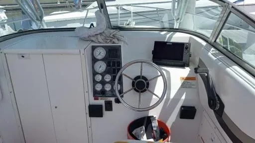 Slide: The Image of 2001 Seaswirl Striper 2600 Sport Cabin I/O helm with steering wheel and gauges. - 12