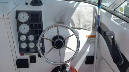 Slide: The Image of 2001 Seaswirl Striper 2600 Sport Cabin I/O helm with gauges and steering wheel. - 14