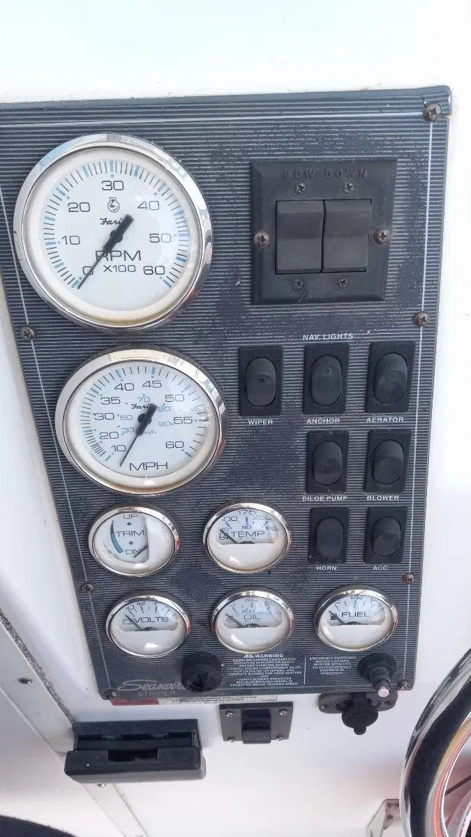 Slide: The Image of Dashboard of a 2001 Seaswirl Striper 2600 Sport Cabin I/O with gauges and switches. - 15