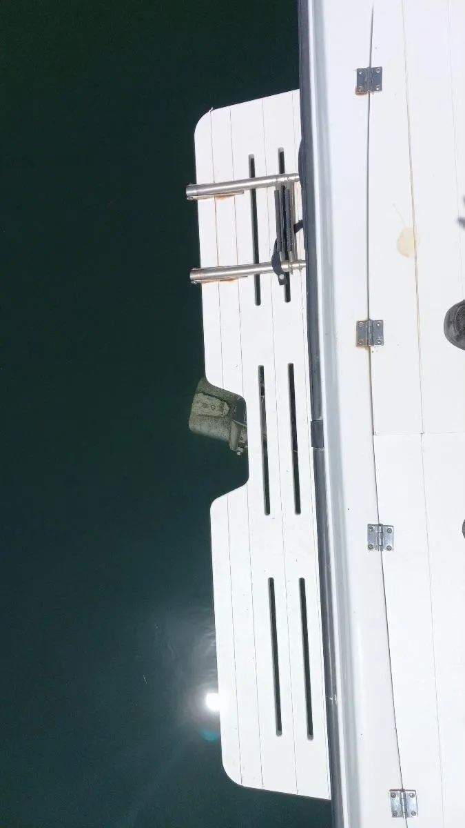 Slide: The Image of 2001 Seaswirl Striper 2600 Sport Cabin I/O swim platform with ladder over water. - 16