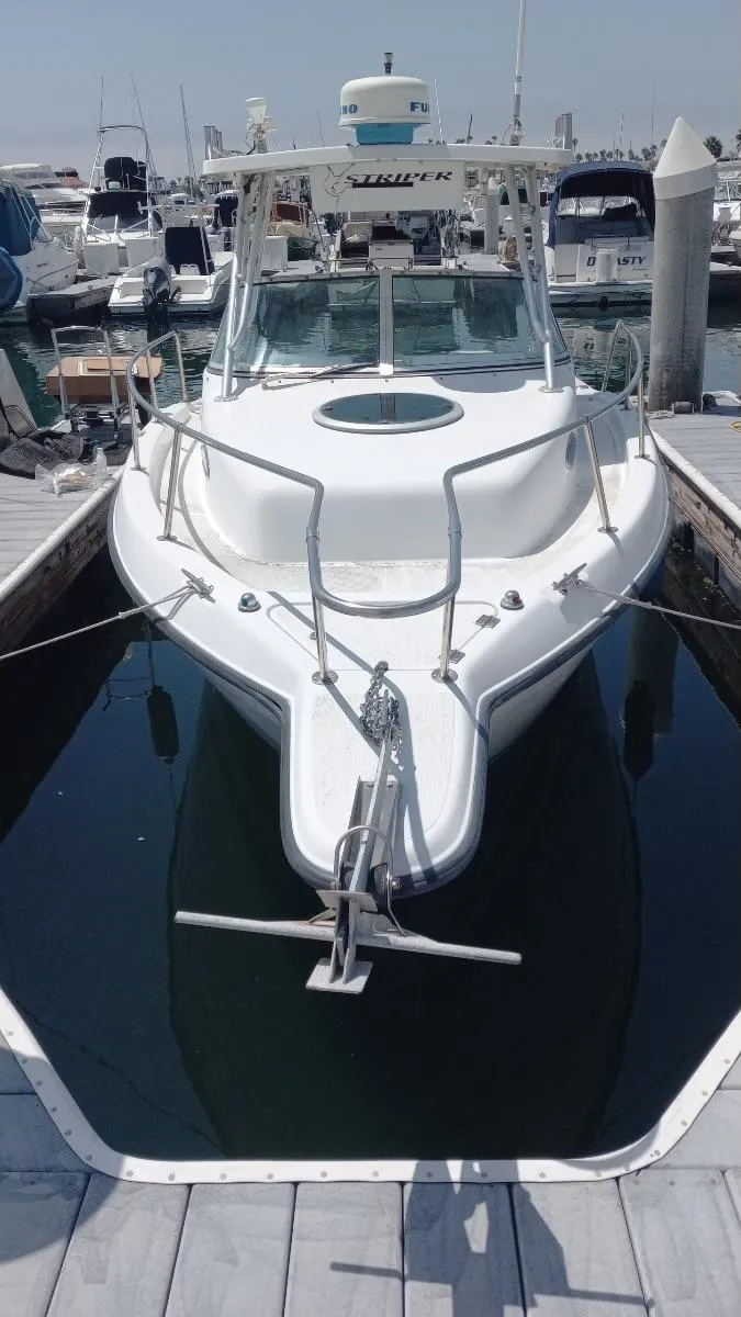 Slide: The Image of 2001 Seaswirl Striper 2600 Sport Cabin I/O docked at marina. - 19