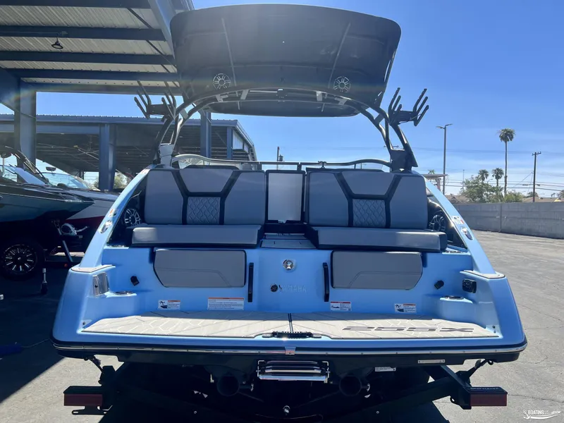 Slide: The Image of 2025 Yamaha Boats 255XD rear view, showcasing seating and deck features. - 2