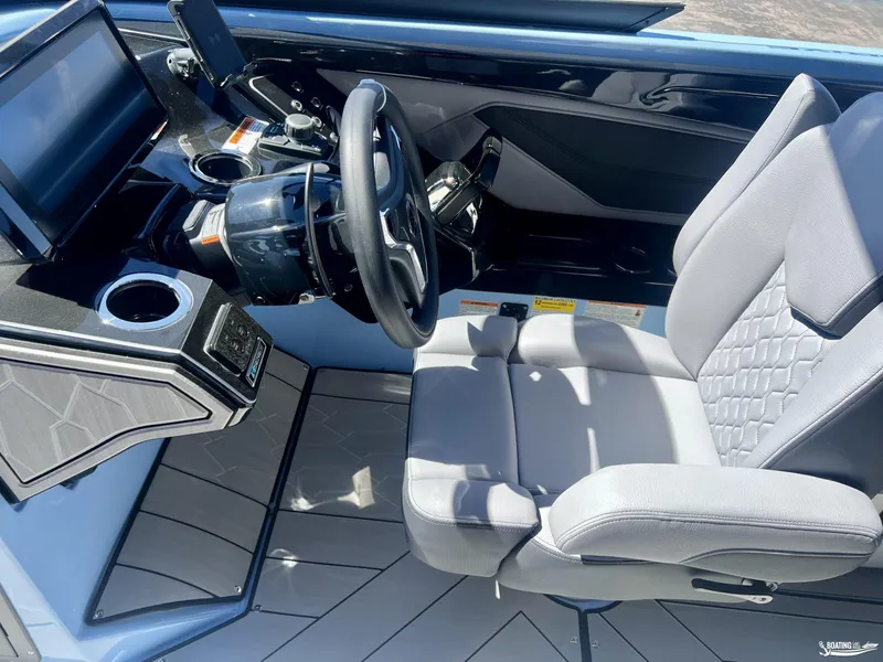 Slide: The Image of 2025 Yamaha Boats 255XD cockpit with modern steering and seating. - 8