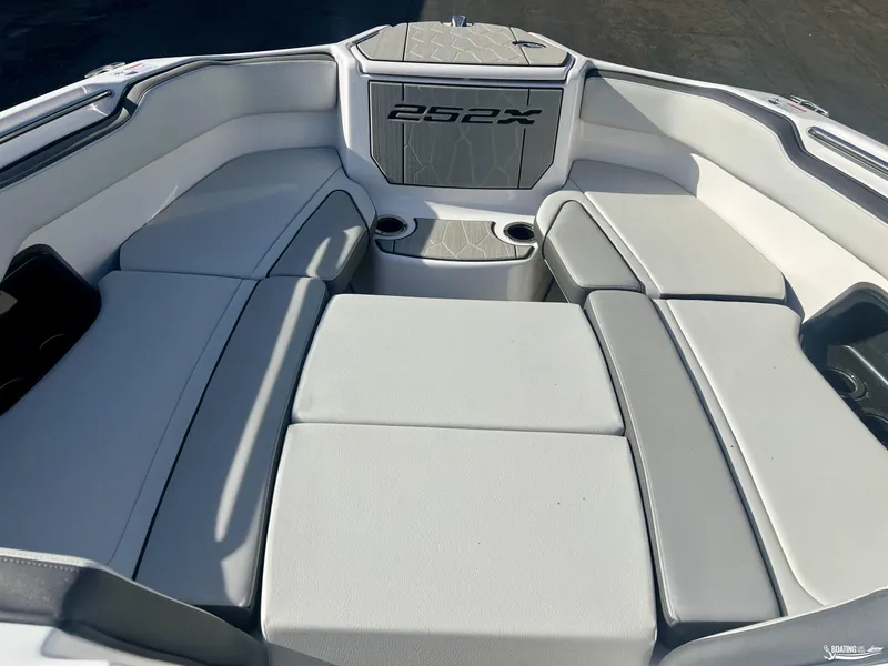 Slide: The Image of 2025 Yamaha Boats 252XE interior seating area with sleek, modern design and comfortable cushions. - 3