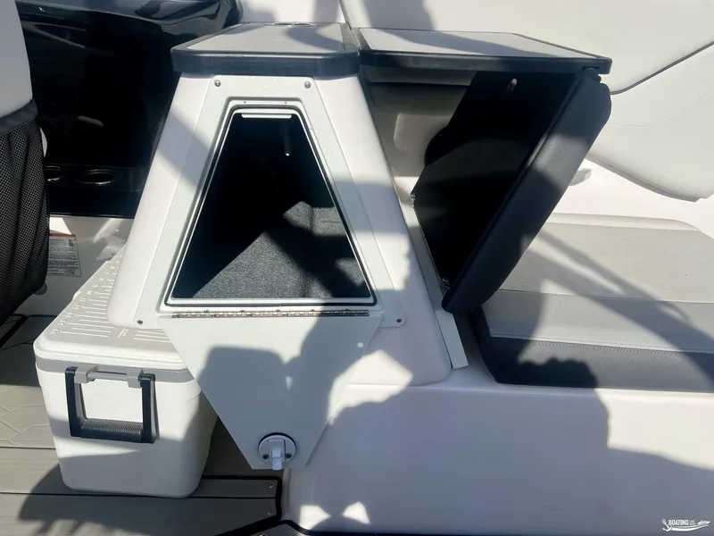 Slide: The Image of 2025 Yamaha Boats 252XE interior storage compartment with open lid and cooler. - 5