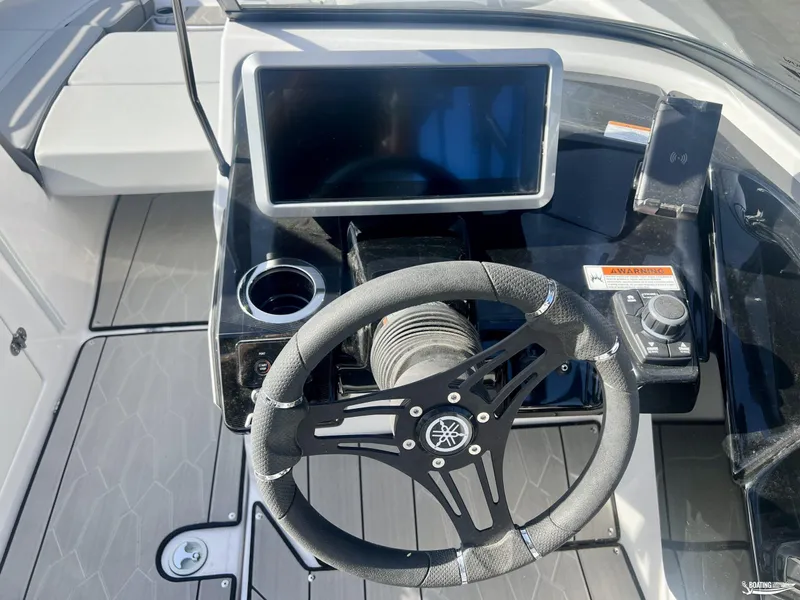 Slide: The Image of 2025 Yamaha Boats 252XE dashboard with steering wheel and touchscreen display. - 8