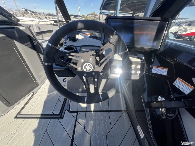 Slide: The Image of 2025 Yamaha Boats 222XE steering wheel and dashboard with touchscreen display. - 6