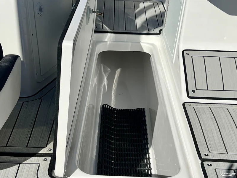 Slide: The Image of 2025 Yamaha Boats 195S storage compartment with open hatch and non-slip flooring. - 7
