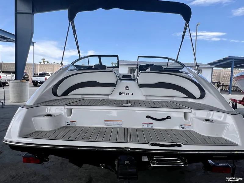 Slide: The Image of 2024 Yamaha SX195 boat, rear view, showcasing sleek design and spacious deck. - 2