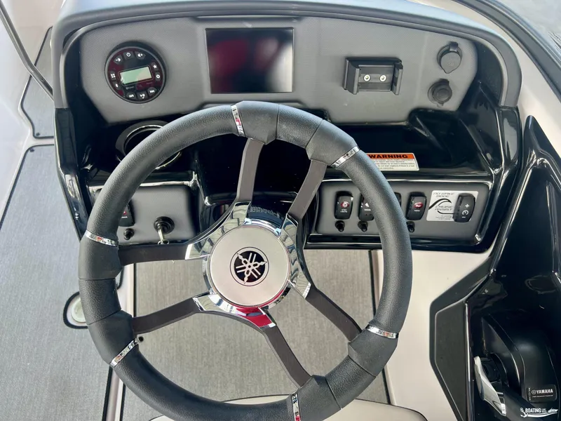 Slide: The Image of 2024 Yamaha Boats SX195 steering wheel and dashboard controls. - 5