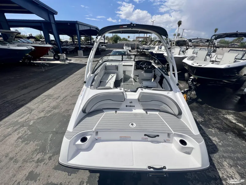 Slide: The Image of 2024 Yamaha AR190 boat in marina, showcasing sleek design and spacious interior. - 1