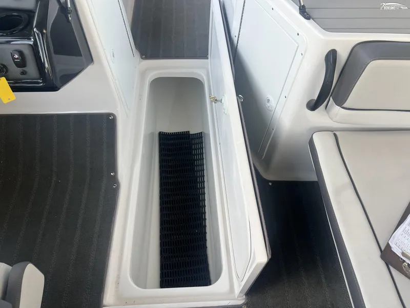 Slide: The Image of 2024 Yamaha AR190 boat interior storage compartment with black mat. - 8