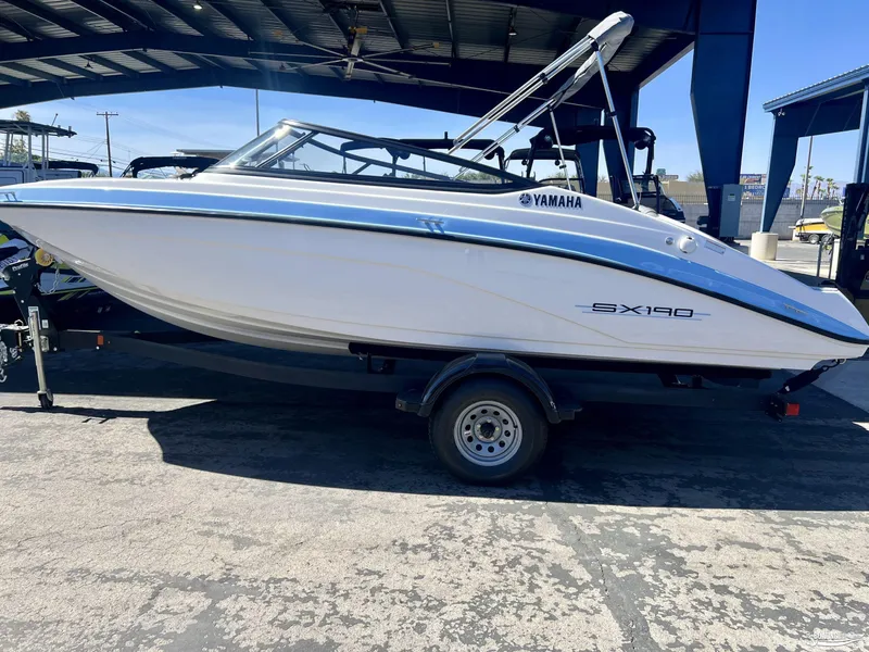 Slide: The Image of 2025 Yamaha SX190 boat on trailer under a canopy. - 0