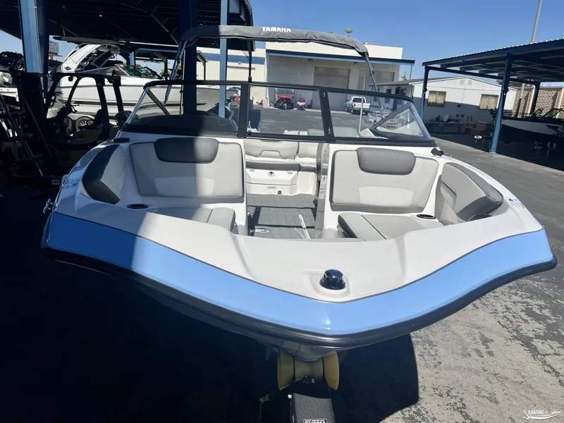 Slide: The Image of 2025 Yamaha SX190 boat with spacious seating, displayed in a marina setting. - 1