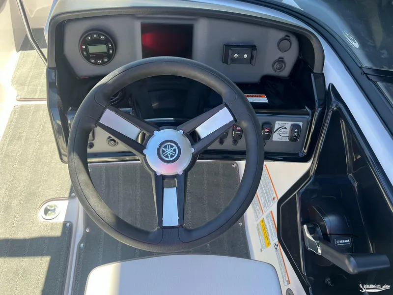 Slide: The Image of 2025 Yamaha Boats SX190 steering wheel and dashboard controls. - 2