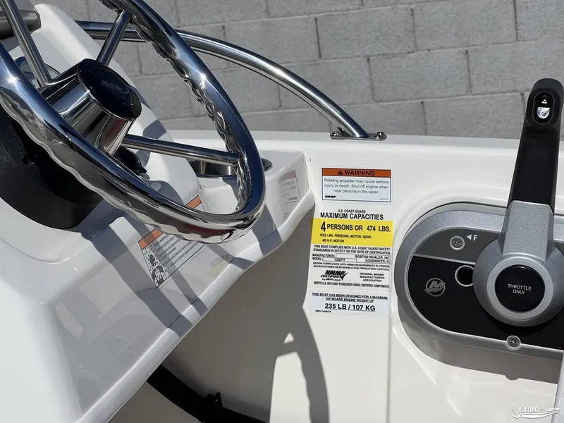 Slide: The Image of 2024 Boston Whaler 130 Super Sport steering wheel and throttle controls. - 4