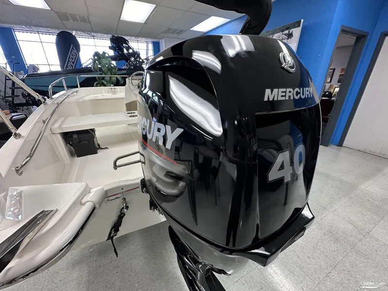 Slide: The Image of 2024 Boston Whaler 130 Super Sport with Mercury 40 outboard engine in showroom. - 8