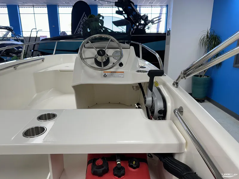 Slide: The Image of 2024 Boston Whaler 130 Super Sport interior with steering wheel and controls. - 9