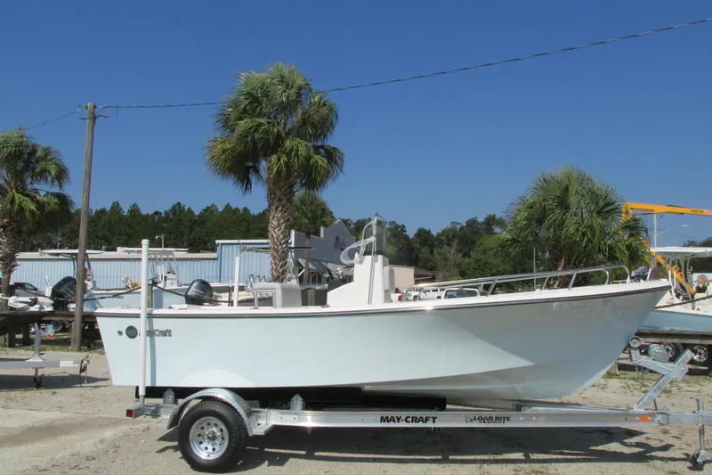 Slide: The Image of 2023 May-Craft 1900CC boat on trailer with palm trees in the background. - 1