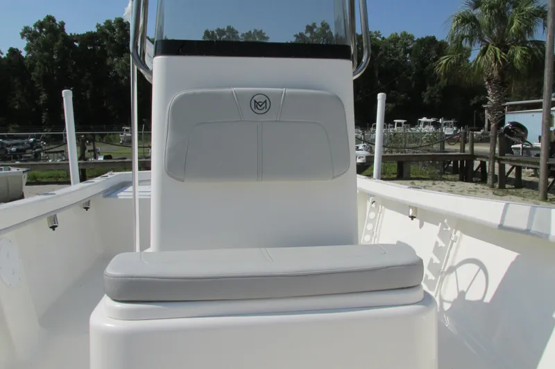 Slide: The Image of 2023 May-Craft 1900CC center console boat interior with cushioned seating. - 13