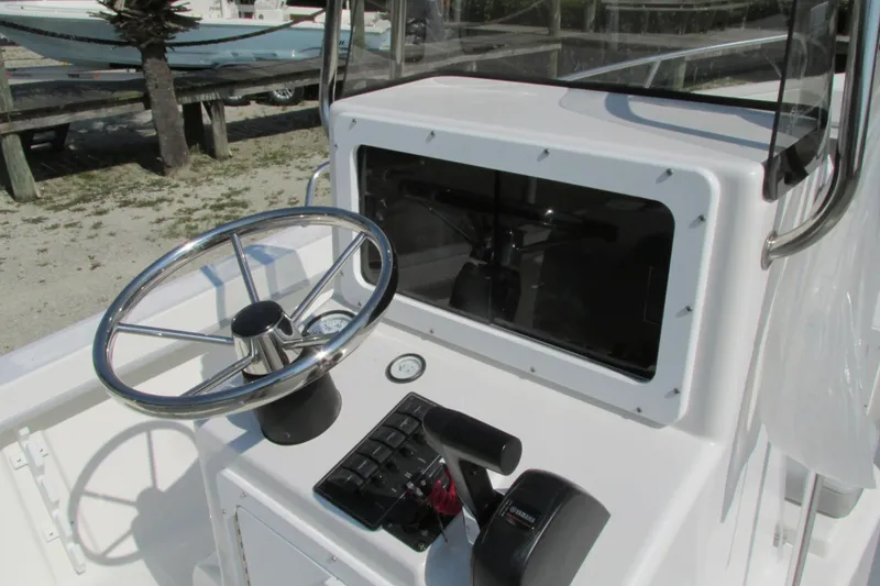 Slide: The Image of 2023 May-Craft 1900CC boat console with steering wheel and controls. - 8