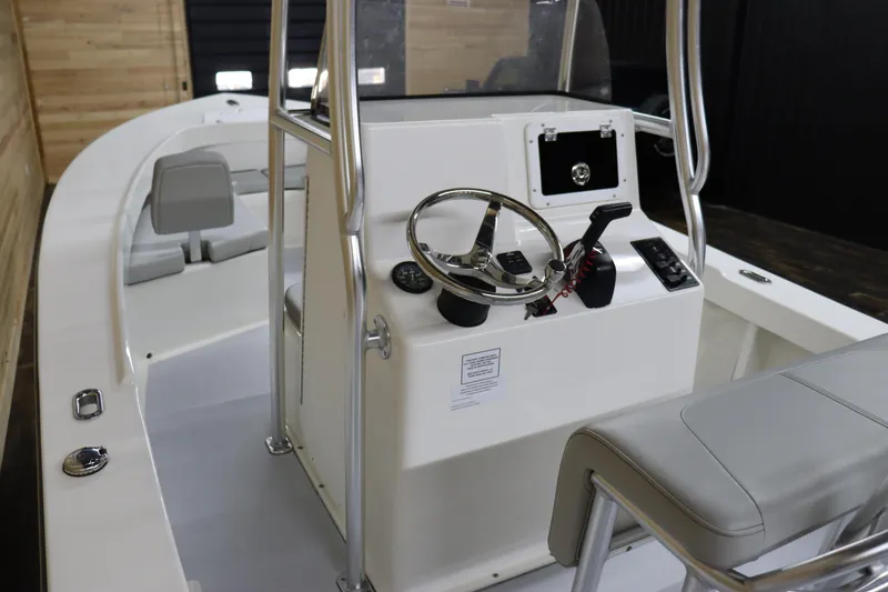 Slide: The Image of 2023 May-Craft 23 Cape Classic boat interior with steering console and seating. - 10