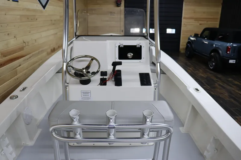 Slide: The Image of 2023 May-Craft 23 Cape Classic boat interior with steering console and rod holders. - 11