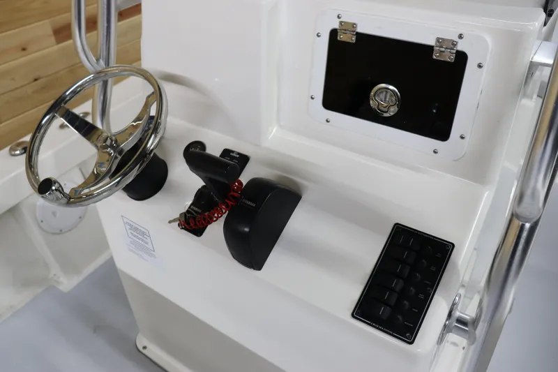 Slide: The Image of 2023 May-Craft 23 Cape Classic boat console with steering wheel and controls. - 12