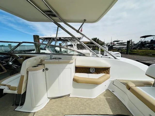 Slide: The Image of Interior of a 2015 Cobalt 302 boat with beige seating and white cabinetry. - 11