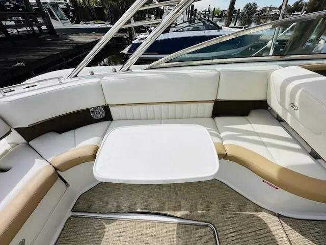 Slide: The Image of Interior seating area of a 2015 Cobalt 302 boat with white and tan upholstery. - 13