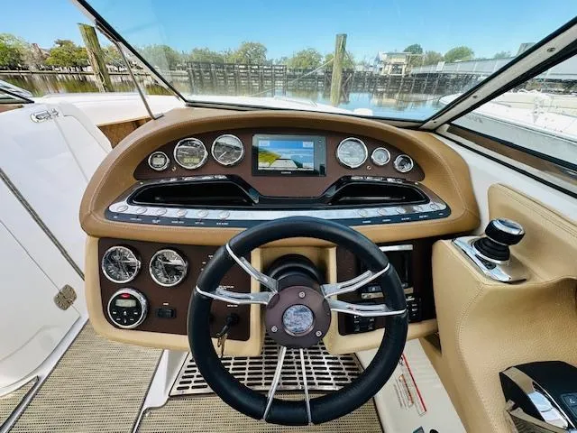 Slide: The Image of 2015 Cobalt 302 boat dashboard with steering wheel and navigation system. - 16