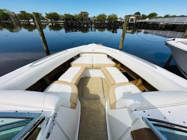 Slide: The Image of 2015 Cobalt 302 boat with spacious seating docked by calm waters. - 22