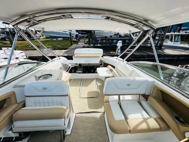 Slide: The Image of 2015 Cobalt 302 boat interior with beige and white seating, docked at marina. - 28