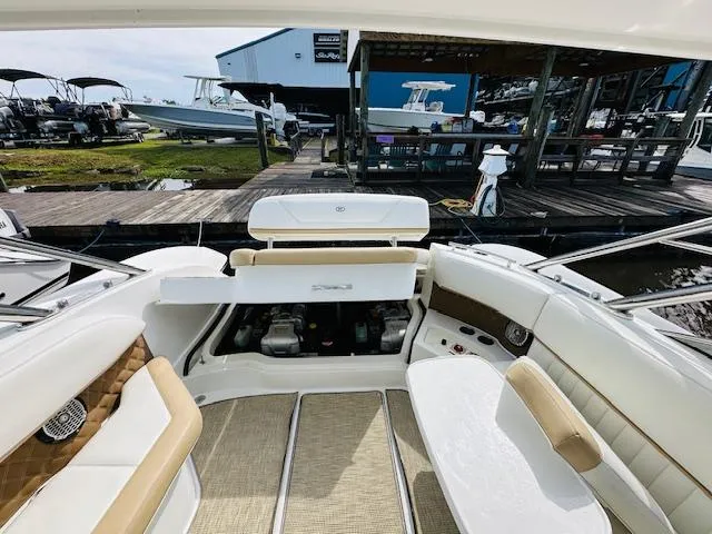 Slide: The Image of 2015 Cobalt 302 boat interior with open engine compartment at marina. - 29