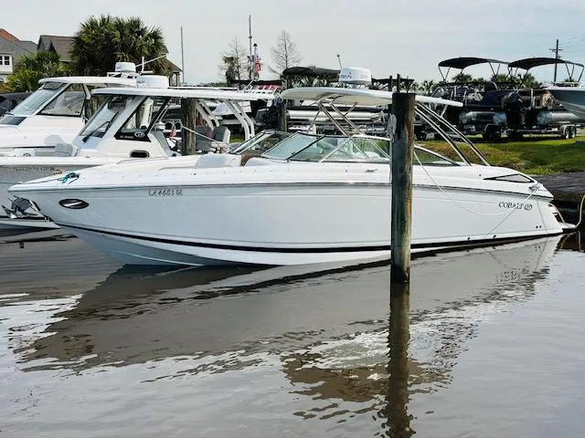 Slide: The Image of 2015 Cobalt 302 boat docked in a marina. - 3