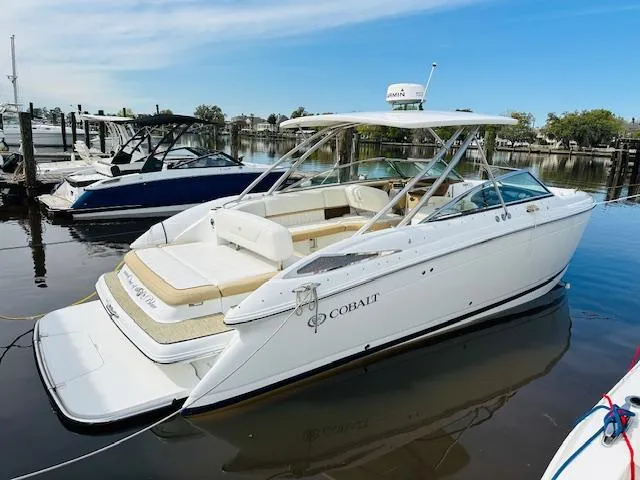 Slide: The Image of 2015 Cobalt 302 boat docked in a marina. - 5