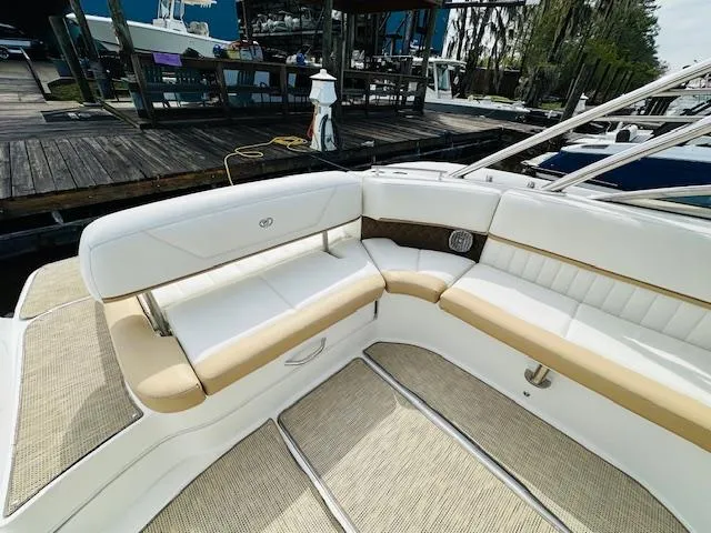 Slide: The Image of Interior seating of a 2015 Cobalt 302 boat docked at a marina. - 9