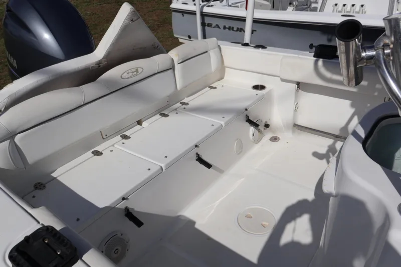 Slide: The Image of 2017 Sea Hunt 234 Ultra boat interior with seating and storage compartments. - 11