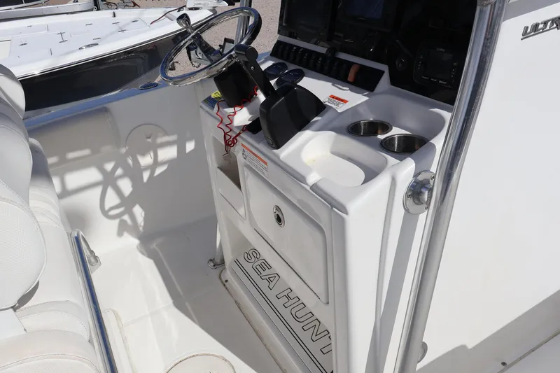 Slide: The Image of 2017 Sea Hunt 234 Ultra boat console with steering wheel and cup holders. - 13
