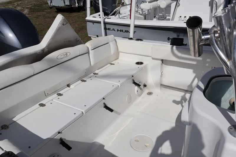 Slide: The Image of 2017 Sea Hunt 234 Ultra boat interior with seating and storage compartments. - 14