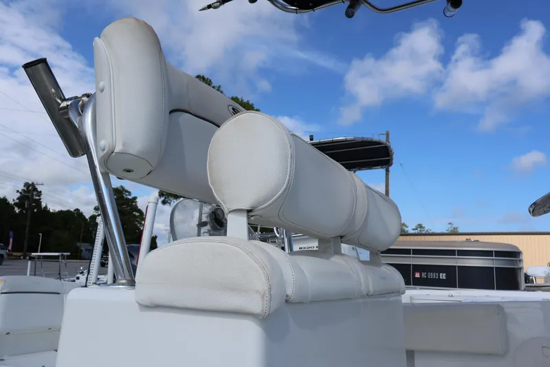 Slide: The Image of 2017 Sea Hunt 234 Ultra boat seating and rod holder against blue sky. - 9