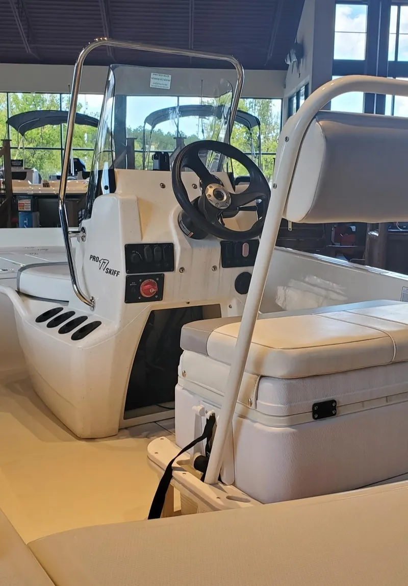 Slide: The Image of 2023 Mako Pro Skiff 17 CC boat interior with steering console and seating. - 6
