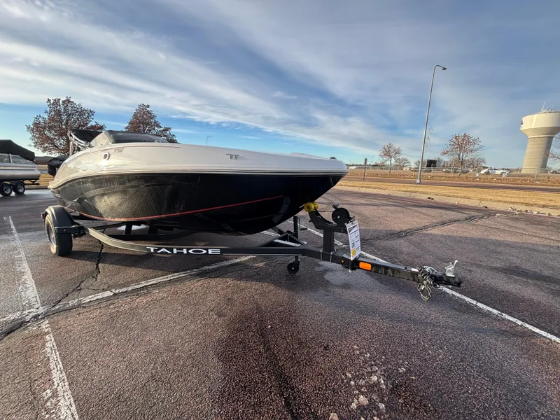 Slide: The Image of 2023 Tahoe T16 boat on trailer in parking lot under cloudy sky. - 5