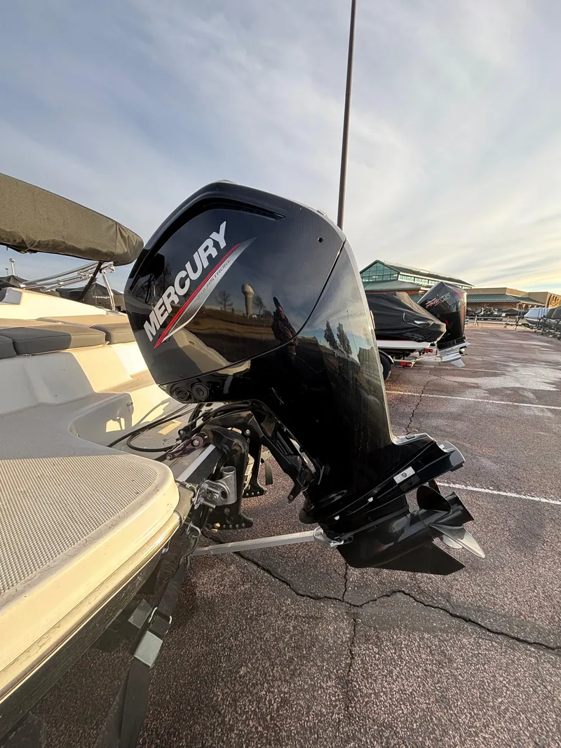 Slide: The Image of 2023 Tahoe T16 boat with Mercury outboard motor in a parking lot. - 7